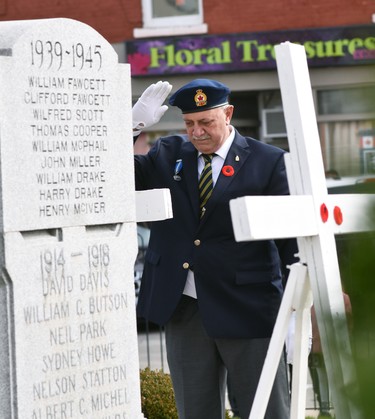Ken Vosper, president of the Royal Canadian Branch of the Mitchell Legion (br. 128), salutes after placing his poppy on one of four ceremonial crosses at the Mitchell cenotaph Nov. 11. ANDY BADER/MITCHELL ADVOCATE