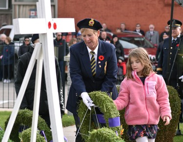 Darlene O'Donnell (left), poppy chair of the Mitchell Legion, br. 128, is assisted by granddaughter Isla Bromfield, 7, of Mount Brydes in laying a wreath during the Remembrance Day ceremony Nov. 11. ANDY BADER