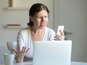 Stock photo of person confused/upset with what they're seeing on screens