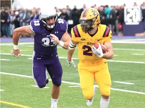 Western Mustangs linebacker Riley MacLeod chases Queen's Gaels running back Jared Chisari