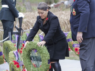 Councillor Lisa Osanic places a wreath during the Captain Matthew J. Dawe Memorial Branch Remembrance Day service in W. C Warnica Memorial Park in Kingston, Ont. on Saturday, Nov. 11, 2023.