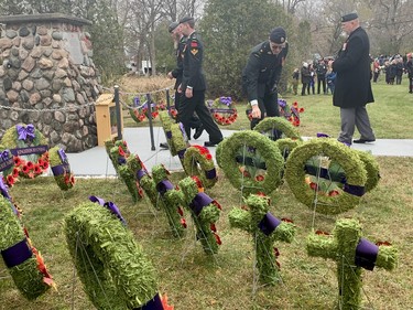 Many placed their poppy on the wreaths after the Captain Matthew J. Dawe Memorial Branch Remembrance Day cenotaph service in W. C Warnica Memorial Park in Kingston, Ont. on Saturday, Nov. 11, 2023.