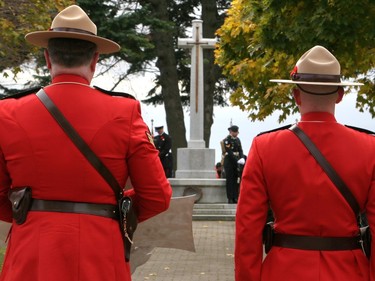 Members of the Royal Canadian Mounted Police lead guests and officials in wreath laying at the foot of the Cross of Sacrifice at Macdonald Memorial Park on Saturday as part of the city's civic Remembrance Day ceremony. A large gathering of military personnel, veterans, first responders, officials and residents attended the annual event on a cold but sunny morning. (Jan Murphy/The Kingston Whig-Standard/Postmedia Network)