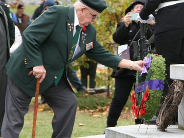 A wreath is laid at the foot of the Cross of Sacrifice at Macdonald Memorial Park on Saturday as part of the city's civic Remembrance Day ceremony. A large gathering of military personnel, veterans, first responders, officials and residents attended the annual event on a cold but sunny morning. (Jan Murphy/The Kingston Whig-Standard/Postmedia Network)