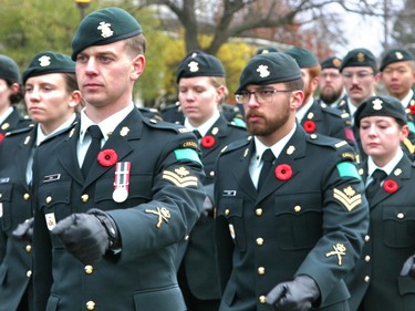 Military personnel lead the Remembrance Day Parade into Macdonald Memorial Park on Saturday as part of the city's civic Remembrance Day ceremony. A large gathering of military personnel, veterans, first responders, officials and residents attended the annual event on a cold but sunny morning. (Jan Murphy/The Kingston Whig-Standard/Postmedia Network)