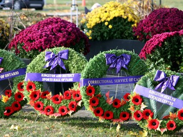 Wreaths are laid at the foot of the Cross of Sacrifice at Macdonald Memorial Park on Saturday as part of the city's civic Remembrance Day ceremony. A large gathering of military personnel, veterans, first responders, officials and residents attended the annual event on a cold but sunny morning. (Jan Murphy/The Kingston Whig-Standard/Postmedia Network)