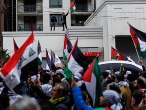 Demonstrators wave Palestinian flags during a protest in Toronto on Oct. 9, 2023. (Photo by Cole Burston, AFP)