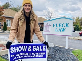 Melissa Matthews, with Big Brothers Big Sisters Sarnia-Lambton, sets up a sign for this weekend's 50th annually fundraising show and sale.