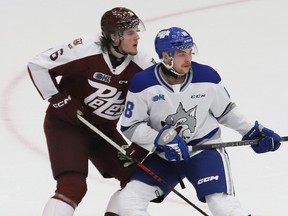 Nick Yearwood, right, of the Sudbury Wolves, and Konnor Smith, of the Peterborough Petes, battle for position during OHL action at the Sudbury Community Arena in Sudbury, Ont. on Friday November 17, 2023.