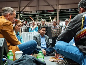 Left to right, seated, are Greg Rickford, Ontario Minister of Indigenous Affairs, Duke Peltier, trustee of the Robinson Huron Treaty Litigation Trust, and Gary Anandasangaree, Minister of Crown–Indigenous Relations. Postmedia