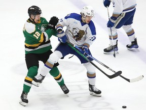 Quentin Musty, right, of the Sudbury Wolves, attempts to skate around Kasper Halttunen, of the London Knights, during OHL action at the Sudbury Community Arena in Sudbury, Ont. on Friday November 24, 2023.