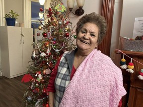 Joyce Morin wears a new pink scarf given to her by the micro-enterprise program at My Sisters' Place in London. (Beatriz Baleeiro/The London Free Press)