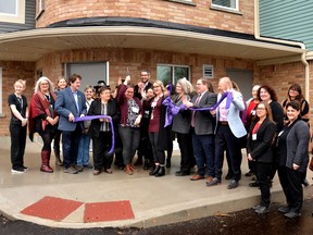 Local politicians, staff and volunteers at Optimism Place Women's Shelter and Support Services in Stratford cut the ribbon on a new, 10-bed expansion at an open-house event Monday afternoon.