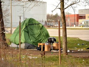 Personal possessions and tents were cleared away from a homeless encampment beside the city transit terminal in downtown Stratford Wednesday. Pictured is a photo of the encampment at the end of November.
