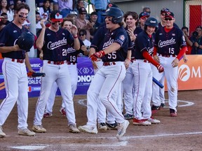 Durham's Alex McGillivray celebrates with teammates after swatting a two-run home run in the bronze medal game of the WBSC Under-18 Men's Softball World Cup. Photo from wbsc.org