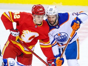 Edmonton Oilers' Seth Griffith, right, lines up during a faceoff against Calgary Flames' Samuel Honzek in an NHL pre-season game at the Scotiabank Saddledome in Calgary Sept. 29. (Gavin Young/Postmedia files)
