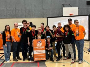 The Cyber Eagles Jade team poses with their Inspire Award banner.
