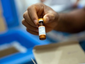 A vial of measles vaccine is checked in this Reuters photo.