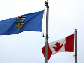 The flags of Alberta and Canada are flown at Syncrude's Beaver Creek Wood Bison Ranch north of Fort McMurray, Alta. on Saturday, June 18, 2022.
