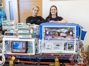 Respiratory therapist Leeann Trowbridge, left, and registered nurse Laura Regier are part of the 20-member neonatal pediatric transport team at Children's Hospital at London Health Sciences Centre. Photograph of them with a transport incubator was taken on Thursday, Nov. 30, 2023, at Victoria Hospital in London. (Derek Ruttan/The London Free Press)