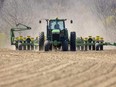 Jordan Fleming, a Delaware-area farmer, harvests corn on a field east of Komoka. (Mike Hensen/The London Free Press)