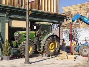 Crews prepare to remove a tractor that has been wedged into a building in downtown Seaforth for two months. Photo taken on Friday Dec. 8, 2023. Mike Hensen/The London Free Press