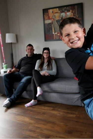 Roxanne Breau and her ex-husband Daniel Dorion are worried about their son, Joémil Dorion, 8 (seen here on an exercise pole in his living room), not receiving an education.