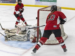 Reese Halliday (right) of the Paris Panthers watches her shot go over the head of St. John's Eagles goalie Spirit Wickson for a goal during an AABHN high school girls hockey game on Wednesday December 6, 2023 at the Brant Sports Complex in Paris, Ontario. Brian Thompson/Brantford Expositor/Postmedia Network