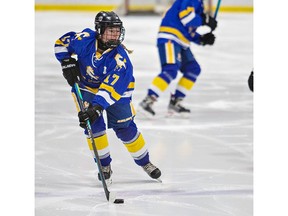 Grace Carson of the BCI Mustangs brings the puck over the blue line