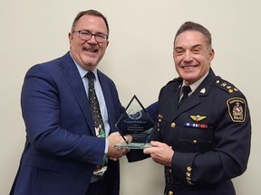 Mayor Darrin Canniff presents a plaque to Chief Gary Conn marking the Chatham-Kent Police Service's 25th anniversary. (Trevor Terfloth/The Daily News)