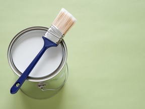 Stock photo of can of white paint and paint brush