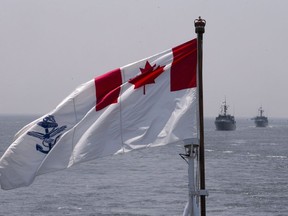 The Royal Canadian Navy Ensign flies on the HMCS Kingston and HMCS Moncton sail behind during the Parade of Ships entering the New York Harbor, Wednesday, May 25, 2016.