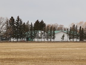 Farm buildings across a field