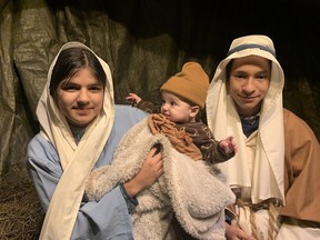 Mary (played by Mckinley Mungal) holds Baby Jesus (Elijah Townsend) with Joseph (Gregory Garcia) at Bethlehem Live, an interactive theatre production put on by Calvary Pentecostal Church in Simcoe. VINCENT BALL
