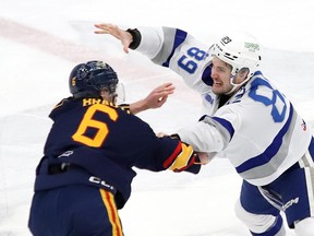 Nathan Villeneuve, right, of the Sudbury Wolves, and Jack Brauti, of the Barrie Colts, scrap during OHL action at the Sudbury Community Arena in Sudbury, Ont. on Friday December 1, 2023.