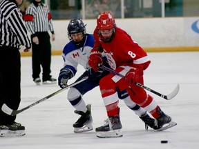Sudbury Wolves forward Mauro Cusinato, left, and Soo Junior Greyhounds forward Curtis Johnston battle for position during Sudbury Regional Silver Stick U16 AA action at Gerry McCrory Countryside Sports Complex in Sudbury, Ontario on Saturday, December 2, 2023.