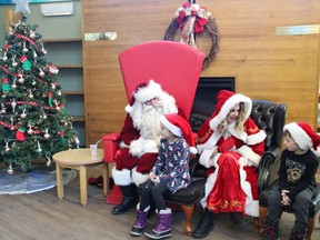 Siblings Mila and Théo Kusins chat with Santa and Mrs. Claus
