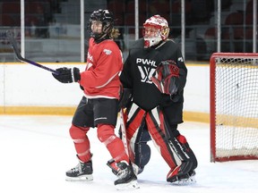 Emily Clark and goalie Emerance Maschmeyer of the PWHL Ottawa women's hockey team mix it up during practice, Dec. 27.