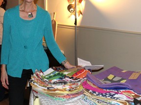 Helen Varekamp stands with the tote bags she made.