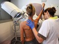 In this file photo, a patient is pictured before mammography. Ontario recently lowered the age for regular breast screening to 40, rather than 50.