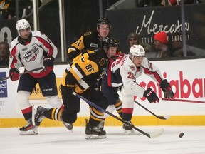 Brantford Bulldogs forward Joshua Avery chips a puck put of his zone on Saturday at the civic centre in an OHL game against the Windsor Spitfires. Brantford won the game 5-1. CHRIS ABBOTT