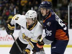 Sarnia Sting's Carson Hall (10) is checked by Flint Firebirds' Marko Stojkov (95) in the first period at Progressive Auto Sales Arena in Sarnia, Ont., on Sunday, Nov. 19, 2023. Mark Malone/Chatham Daily News/Postmedia Network