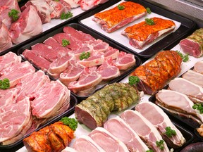 Selection of meat on trays in a display cooler