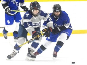 Ingersoll District Collegiate Institute player Olivia Pacheco, right, and Parkside’s Scarlett Wilson duel for puck possession in a TVRA girls high school hockey game at the Ingersoll District Memorial Centre on Thursday, Jan. 11, 2024. (Derek Ruttan/London Free Press)