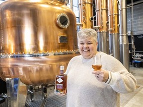 Paradigm Spirits Co. co-founder Michelle Debus pours a generous dram, in the London, Ont.  distillery on Tuesday, Jan.  23, 2024, of their 19 year old whisky, which has been named Canadian whiskey of the year at the Canadian whiskey awards in Victoria, BC (Derek Ruttan/The London Free Press)