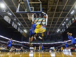 Mike Nuga of the London Lightning gets fouled at the hoop by Curtis Hollis of the KW Titans in their first home game of the Super Basketball League season at Budweiser Gardens in London on Jan. 6, 2023. Mike Hensen/The London Free Press