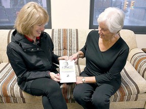 May Court of Club of Chatham members Shirley Loyer, left, and Penny McGregor, look at the brochure for the 2018 women of excellence awards, which was the last big event before the COVID-19 pandemic hit.  Nominations are open for the 2023 women of excellence event which is returning as a full-scale event on April 26. (Tom Morrison/Postmedia Network)