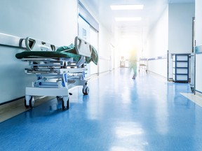 Stock image of hospital bed in a hallway