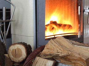 Stock photo of wood-burning fireplace, with wood in foreground