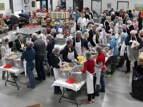 Dozens of volunteers, many of them Rotary club members, pack thousands of food hampers on Saturday at the Community Food Redistribution Warehouse destined for families and those in need in the Kingston area. The packages will supplement the food boxes delivered by the Food Sharing Project, Lionhearts Inc. and Morningstar Mission in Napanee, with Rotary club support.